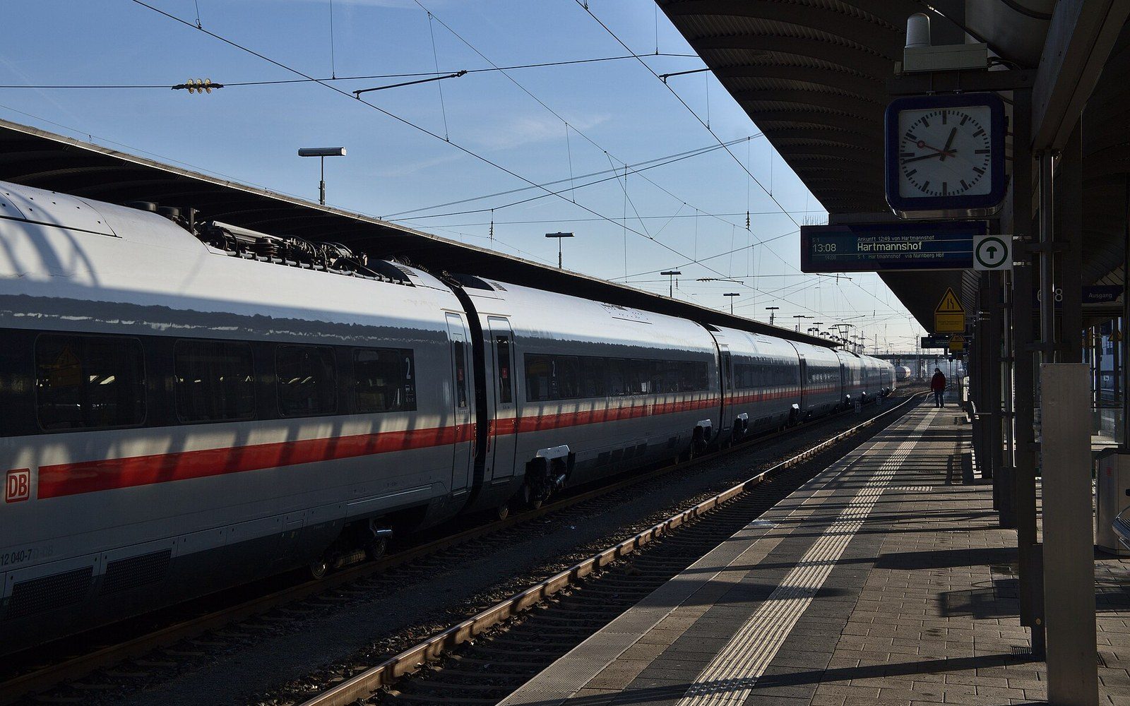 A station platform with a high-speed train alongside